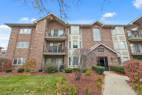 Front view of a multi-story brick apartment building.