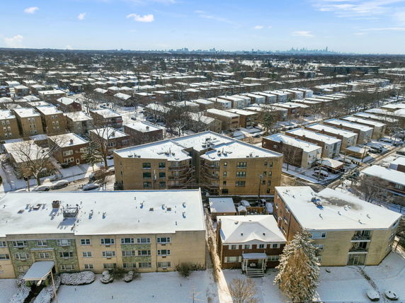 Panoramic view of a residential area with snow-covered buildings and streets.