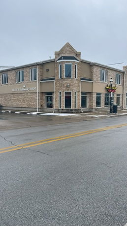 Front view of a two-story commercial building with multiple windows.