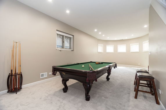 Interior view of a room with a pool table and cue rack.