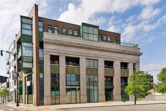 Front view of a multi-story building with a historic facade and modern glass elements.
