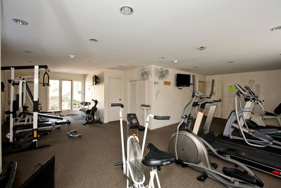 Indoor gym area with various exercise equipment.
