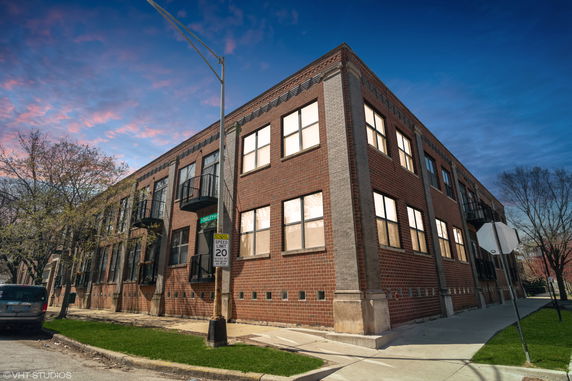 Front view of a two-story brick building with multiple windows.