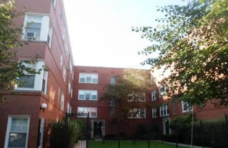 Front view of a multi-story brick apartment building.