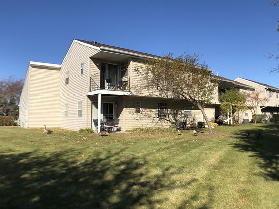 Front view of a two-story house with balconies.