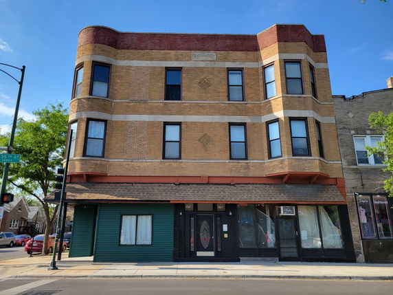 Front view of a three-story mixed-use building.