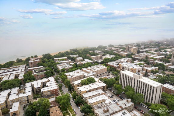 Panoramic view of a cityscape with multiple buildings and a beach in the distance.