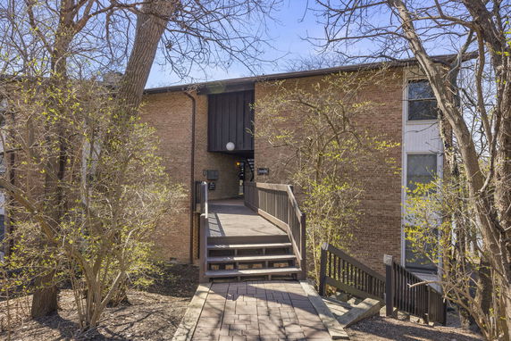 Front view of a two-story brick building with an entrance walkway.