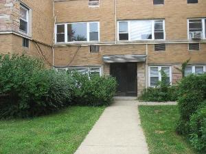 Front view of a multi-story brick building with a central entrance.