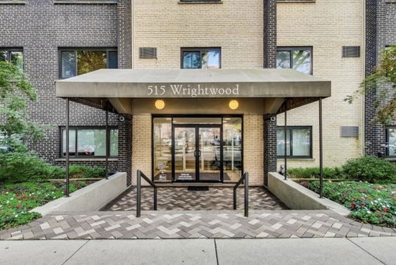 Front view of a building entrance with a covered walkway labeled 515 Wrightwood.
