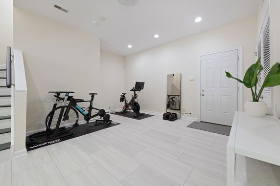 Indoor area with exercise bikes and a mirror on the wall.
