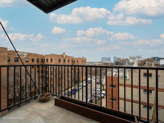 View of surrounding buildings and skyline from a balcony.