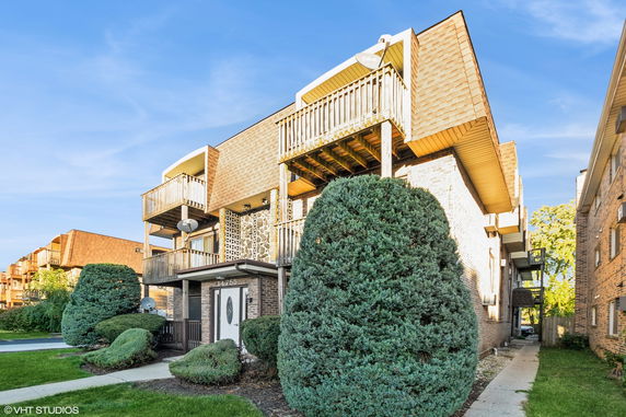 Front view of a multi-story building with balconies.