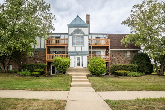 Front view of a multi-story brick building with balconies.