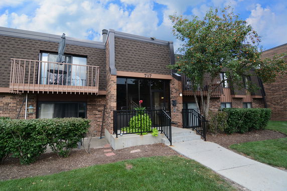 Front view of a two-story brick building with balconies.