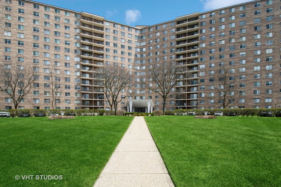 Front view of a multi-story apartment building with a central entrance.