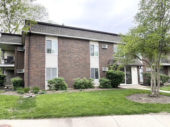 Front view of a two-story brick apartment building.