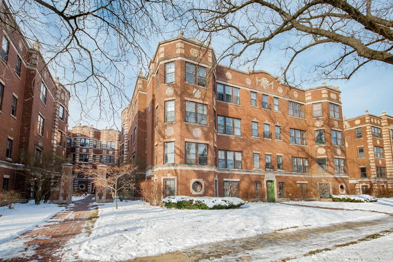 Front view of a multi-story brick apartment building.