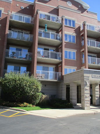 Front view of a multi-story apartment building with balconies.