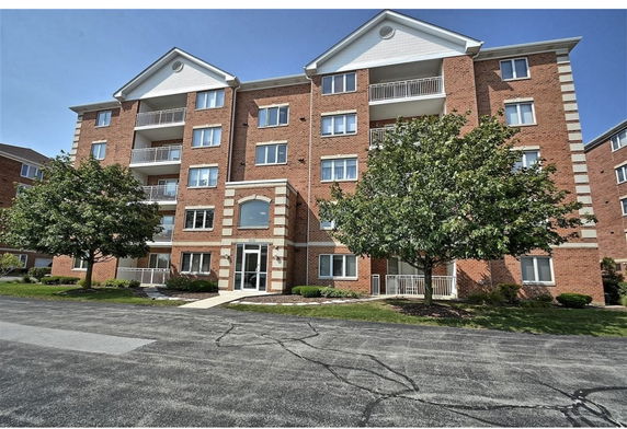 Front view of a multi-story brick apartment building.