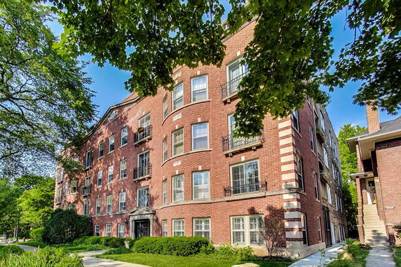 Front view of a multi-story brick apartment building.