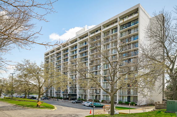 Front view of a multi-story apartment building with balconies.