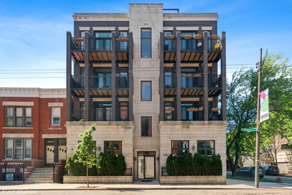 Front view of a multi-story building with balconies.