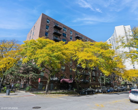 Front view of a multi-story brick building with balconies.