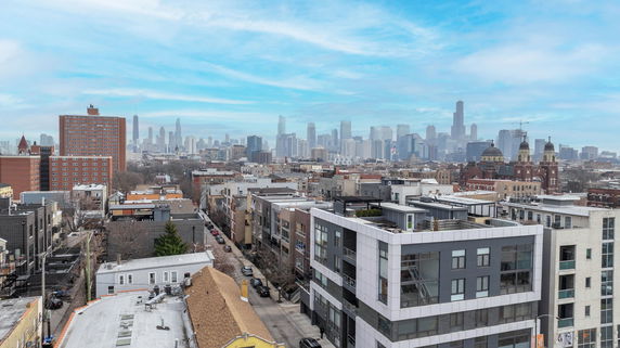 Panoramic view of a cityscape with various buildings and skyscrapers.