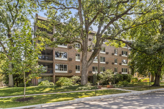 Front view of a multi-story brick apartment building.