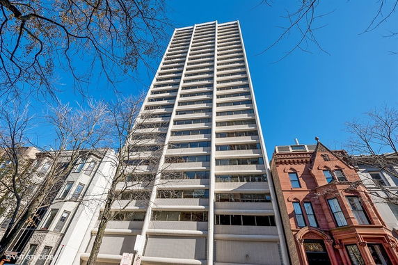 Front view of a tall high-rise building with multiple windows.