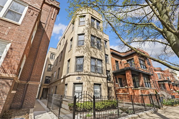 Front view of a multi-story brick residential building.