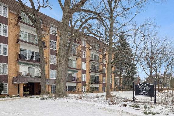 Front view of a multi-story condominium building with balconies.