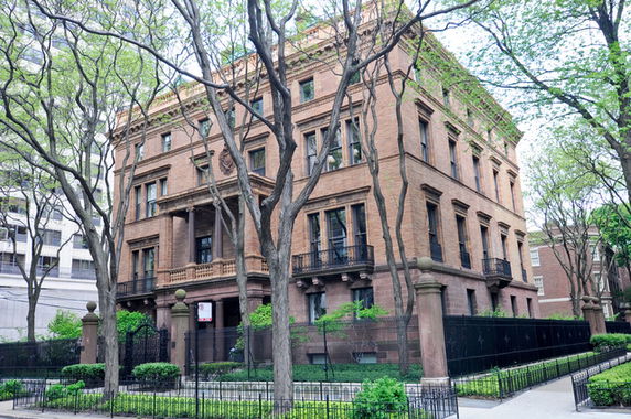 Front view of a large multi-story brick building with ornate architectural details.
