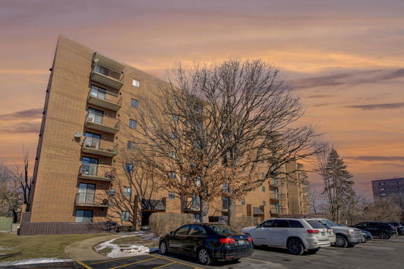 Front view of a multi-story apartment building with balconies.