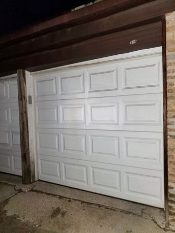 Front view of a garage with a white, paneled garage door.