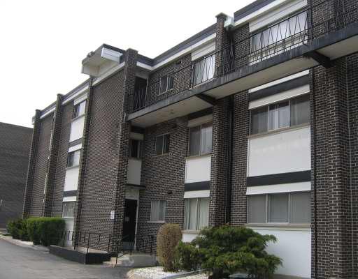 Front view of a multi-story brick apartment building