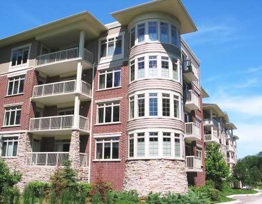 Front view of a multi-story residential building with balconies.
