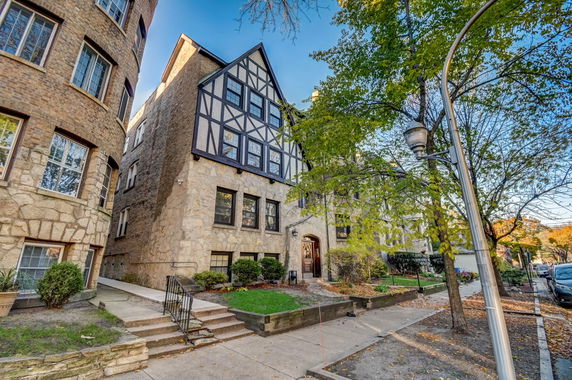 Front view of a multi-story building with a Tudor architectural style.