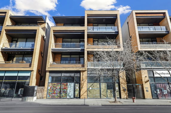 Front view of a multi-story commercial and residential building.