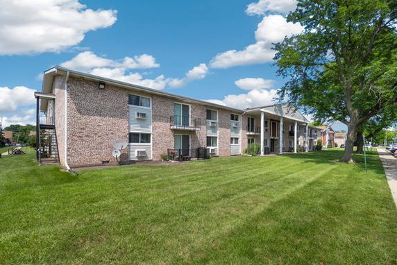 Front view of a two-story residential building with balconies.