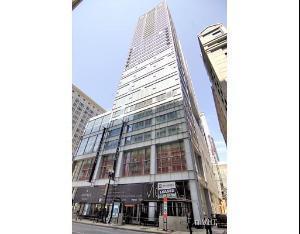 Front view of a tall multi-story building in an urban environment.