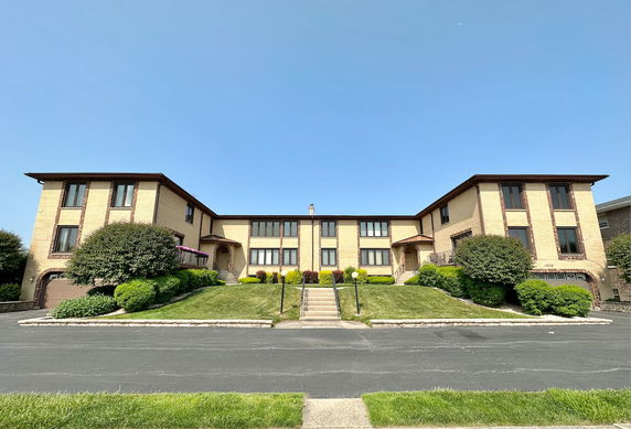 Front view of a two-story apartment building with multiple units.