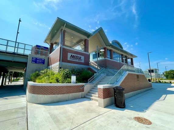 Front view of a station building with stairs and a modern architectural design.