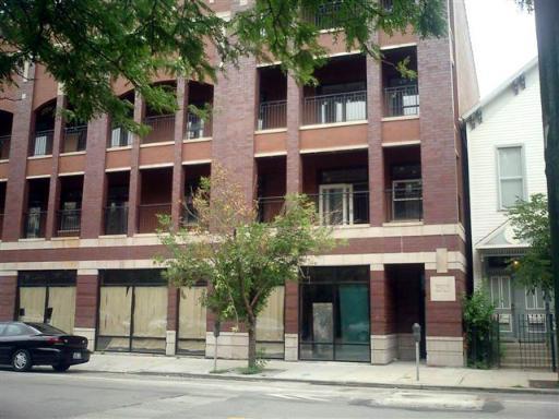 Front view of a multi-story brick building with balconies.