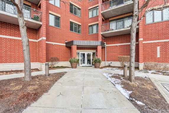 Front view of a multi-story brick building entrance.