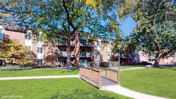 Front view of a multi-story apartment building with balconies.