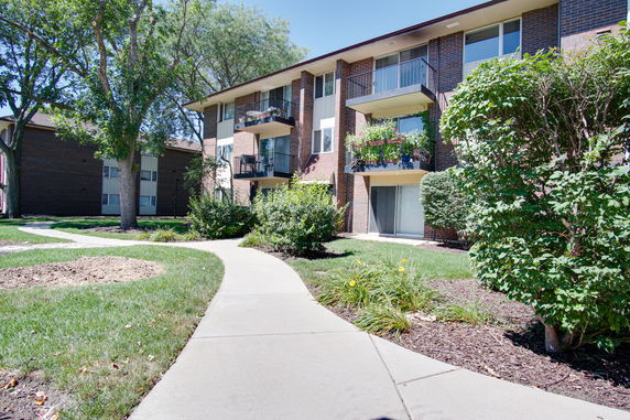Front view of a multi-story apartment building with balconies.
