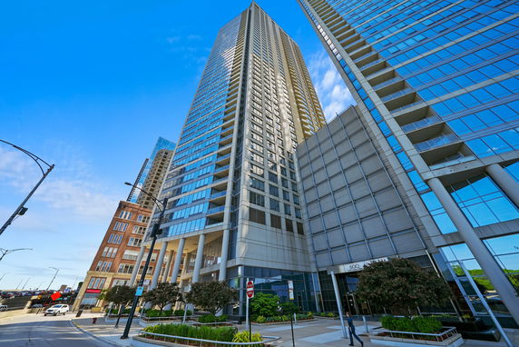 Front view of a modern high-rise building with glass windows.