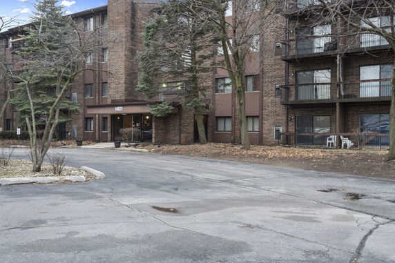 Front view of a multi-story brick apartment building.